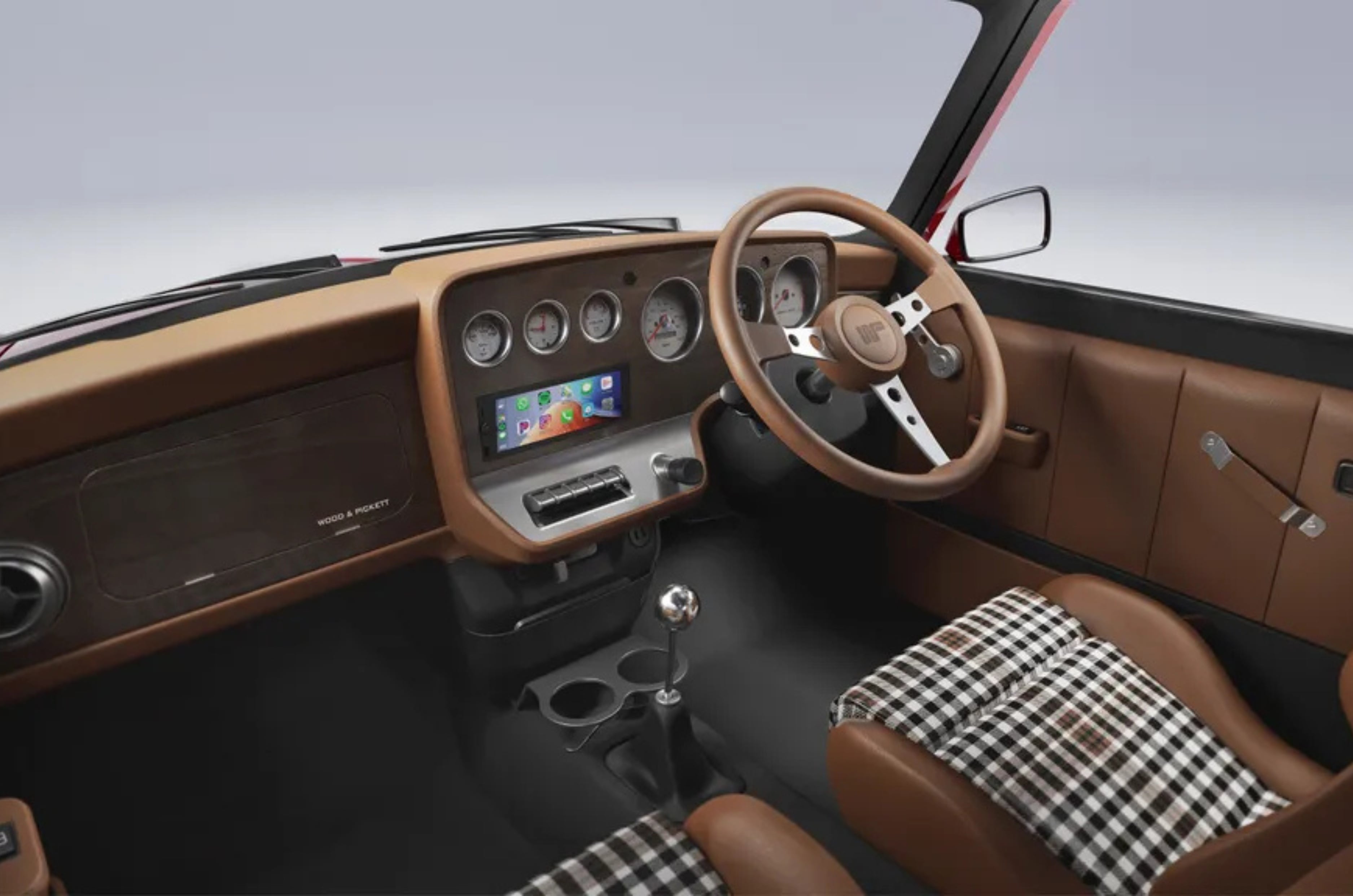 The wooden dashboard is inspired by the walnut panels fitted to Wood & Pickett’s Margrave Mini in the 1960s. 